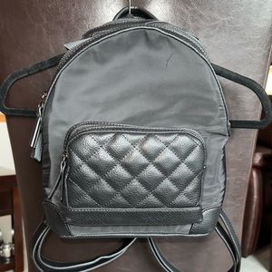 NEW mini backpack. 10”x9” 4 outside zip pockets. Backpack straps OPTIONAL